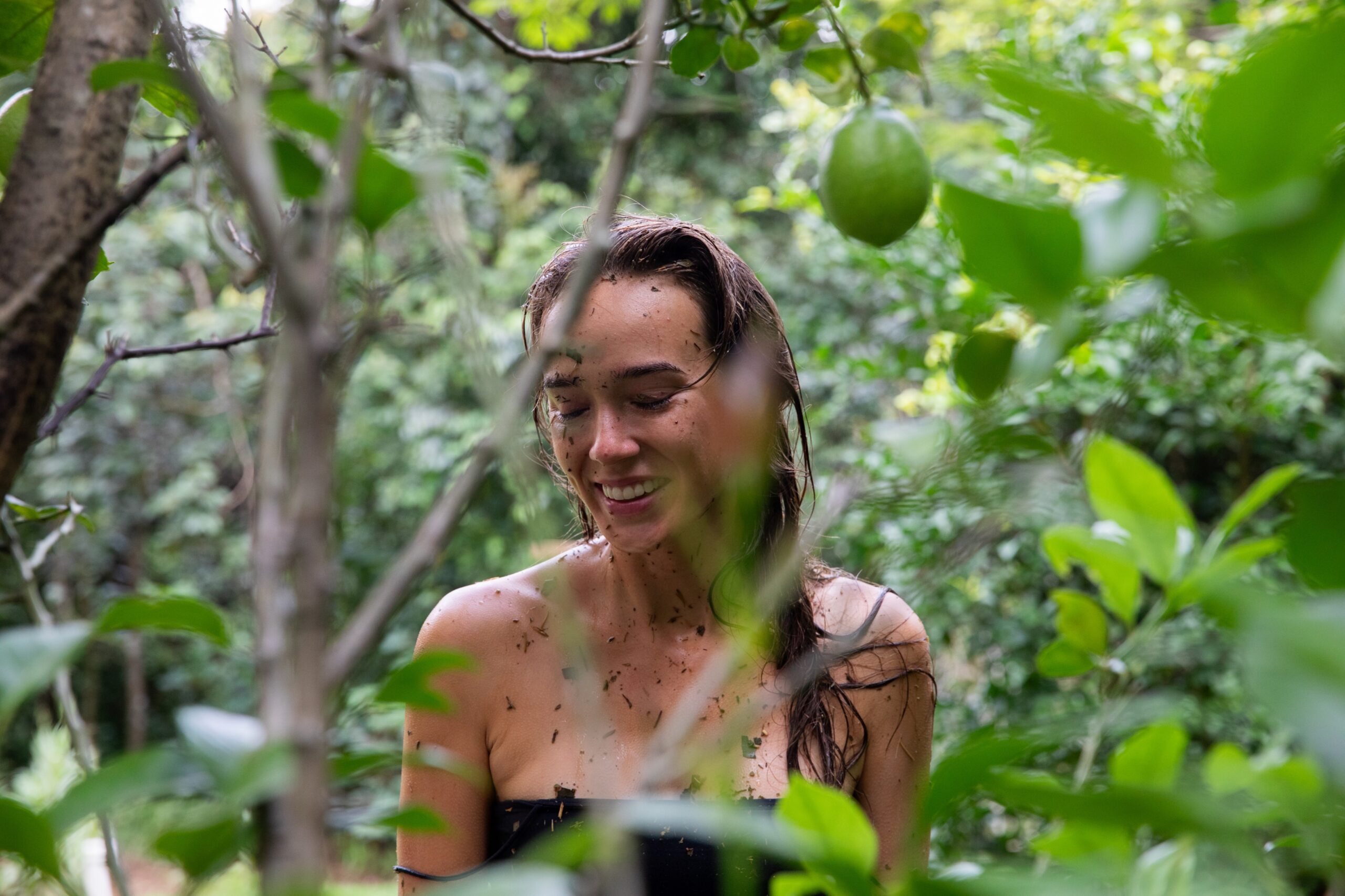 Lisa smiling after a healing bath ritual during her journey in Brazil, representing inner peace and transformation.